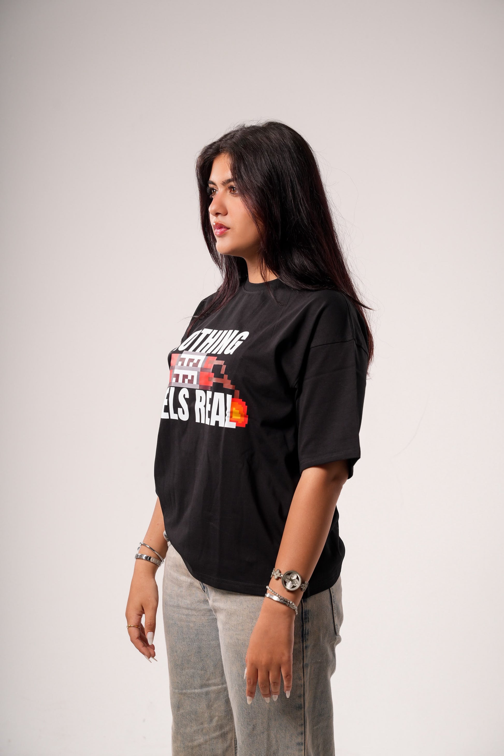 "NOTHING FEELS REAL" STATEMENT TEE