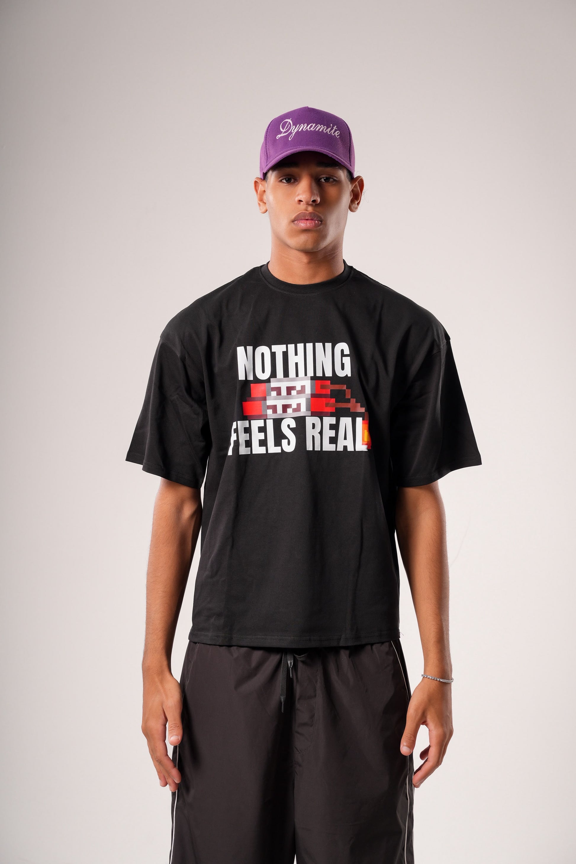 "NOTHING FEELS REAL" STATEMENT TEE