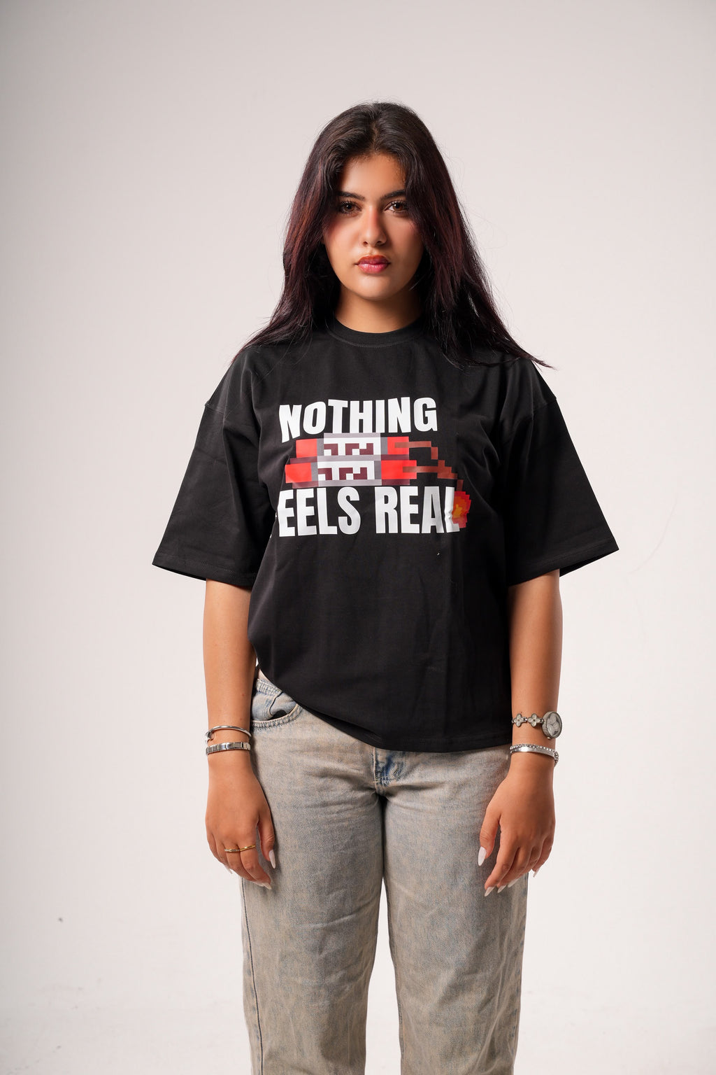 "NOTHING FEELS REAL" STATEMENT TEE