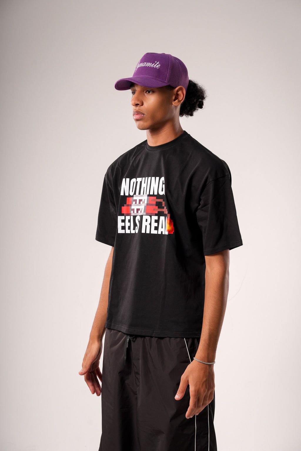 "NOTHING FEELS REAL" STATEMENT TEE