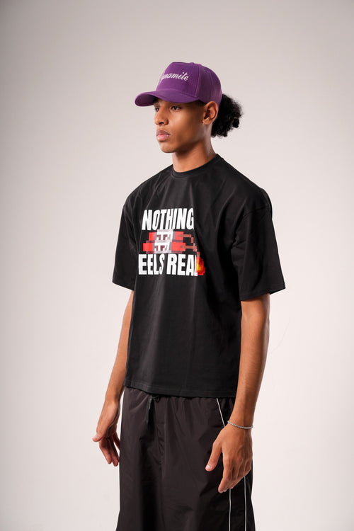 "NOTHING FEELS REAL" STATEMENT TEE